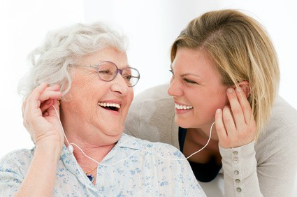 provider of dementia care in Burlington listening to music with senior patient