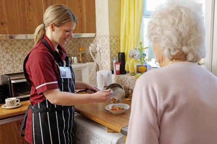 provider of elderly care in Toronto making lunch with senior patient