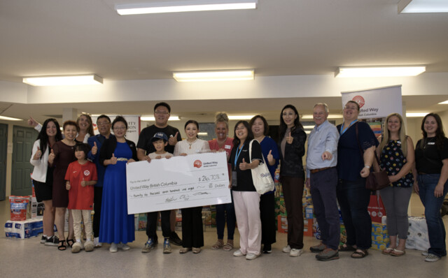 Qualicare team with Chinese Canadian community members presenting a donation cheque to United Way British Columbia for Okanagan wildfire relief