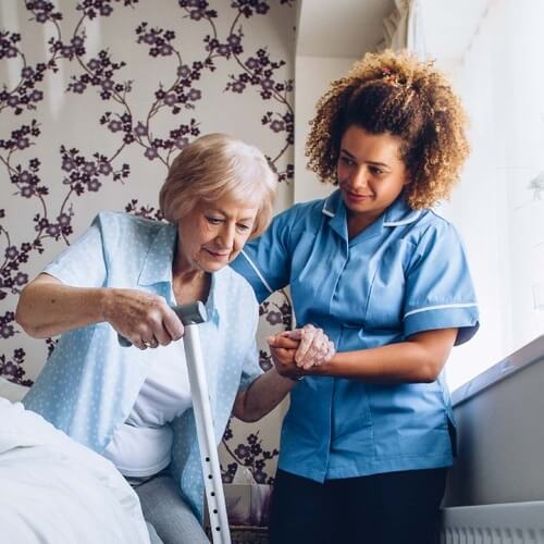 home care agency in Oshawa assisting elderly patient out of bed