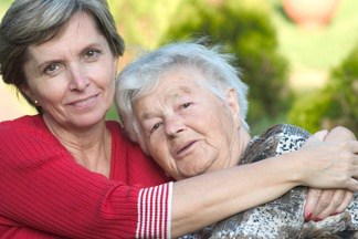 Woman Hugging Elderly Woman