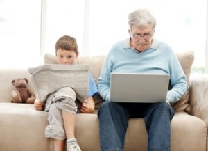 Boy Reading Newspaper with Grandpa