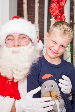 Santa Claus Sitting with Smiling Child