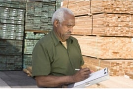 Older man Writing on Clipboard