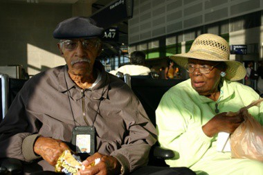 Elder Couple Sitting In Airport