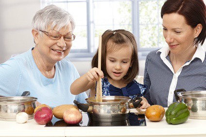 Elderly Woman Cooking with Mother and Daughter