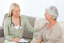 Nurse Talking to Elderly Woman Patient