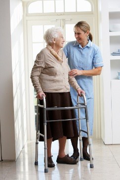 Nurse Helping an Elderly Woman with a Walker