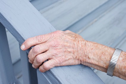 Elderly Hand Holding a Banister 